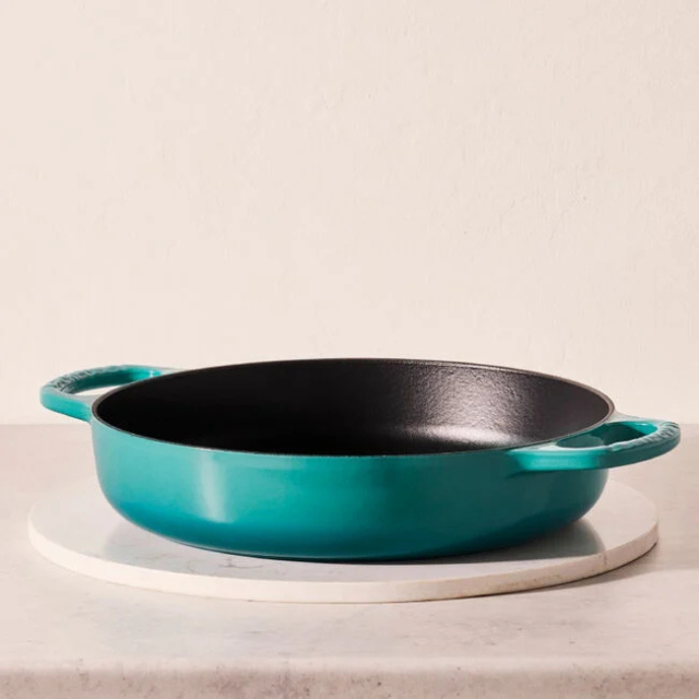 A cookware piece with handles positioned on a countertop