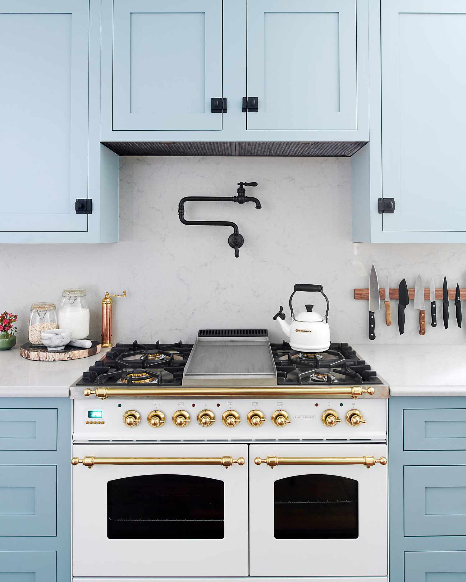 powder blue kitchen with view of stove featuring gold accents