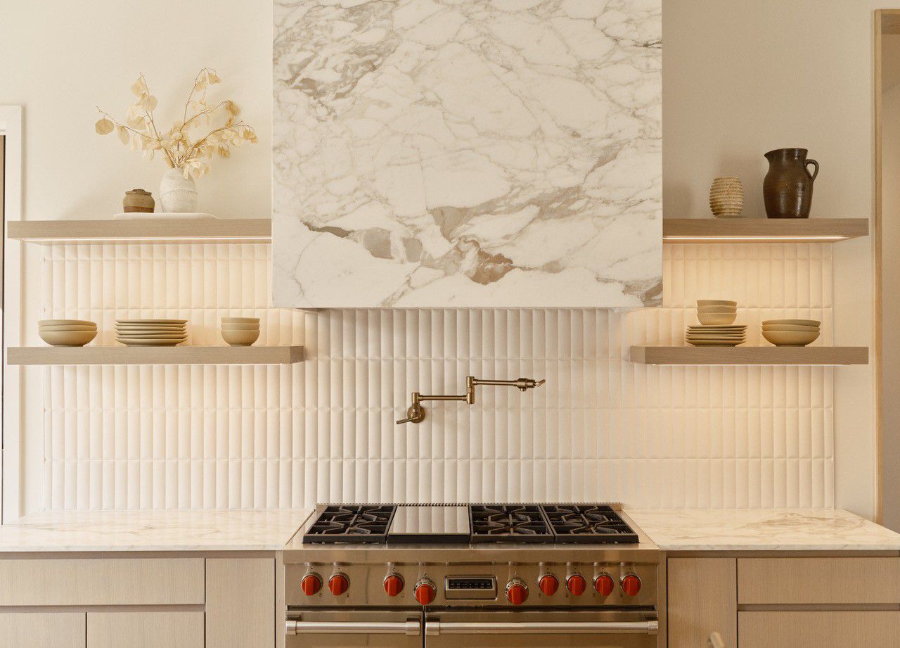 white kitchen with marble hood