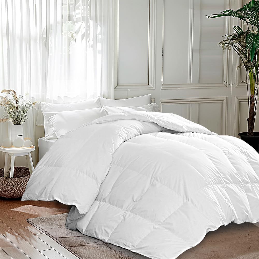 A neatly made bed with a comforter in a welllit room with decor including plants and a stool