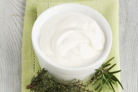 Small bowl of creme fraiche with herbs