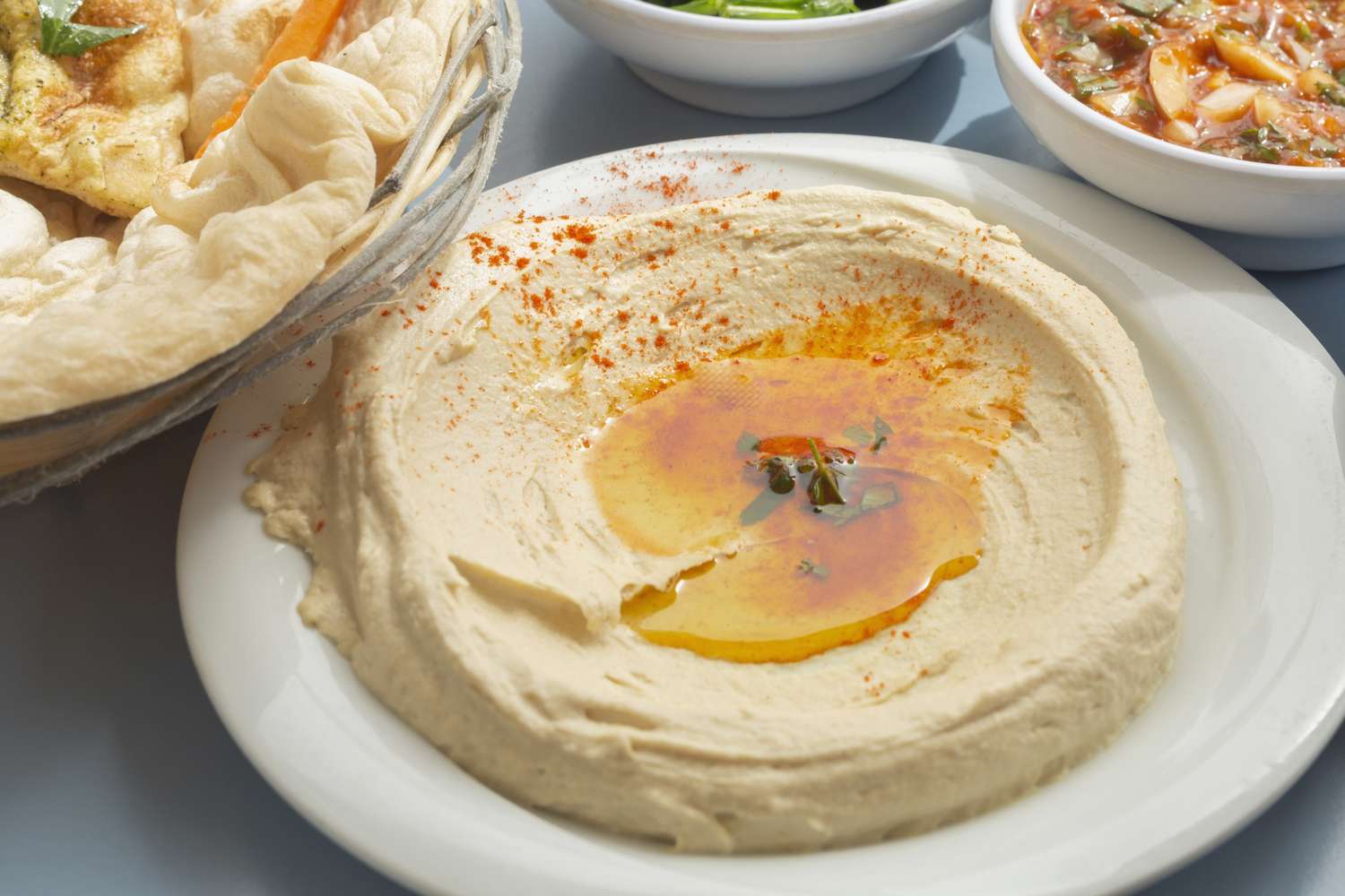 hummus and olive oil on a white plate