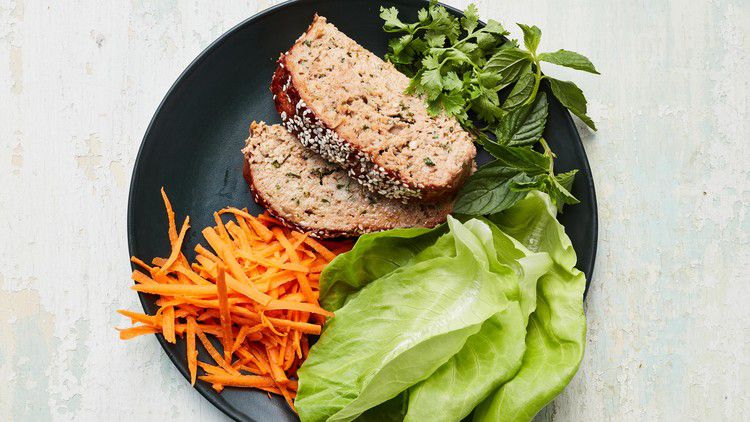 turkey meatloaf with hoisin glaze plated with lettuce carrots and herbs