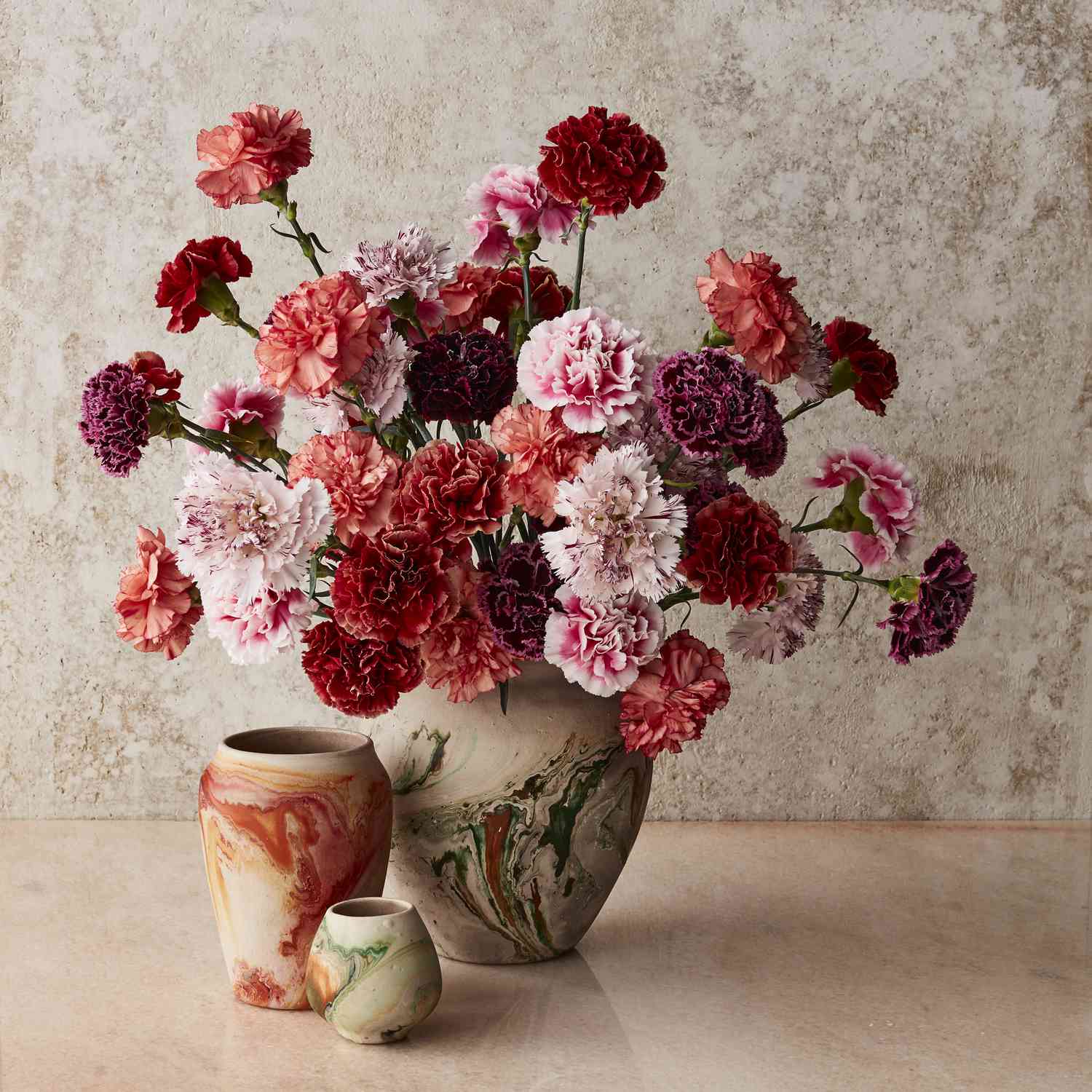 Arrangement of carnations in marbles vases