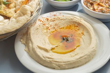hummus and olive oil on a white plate