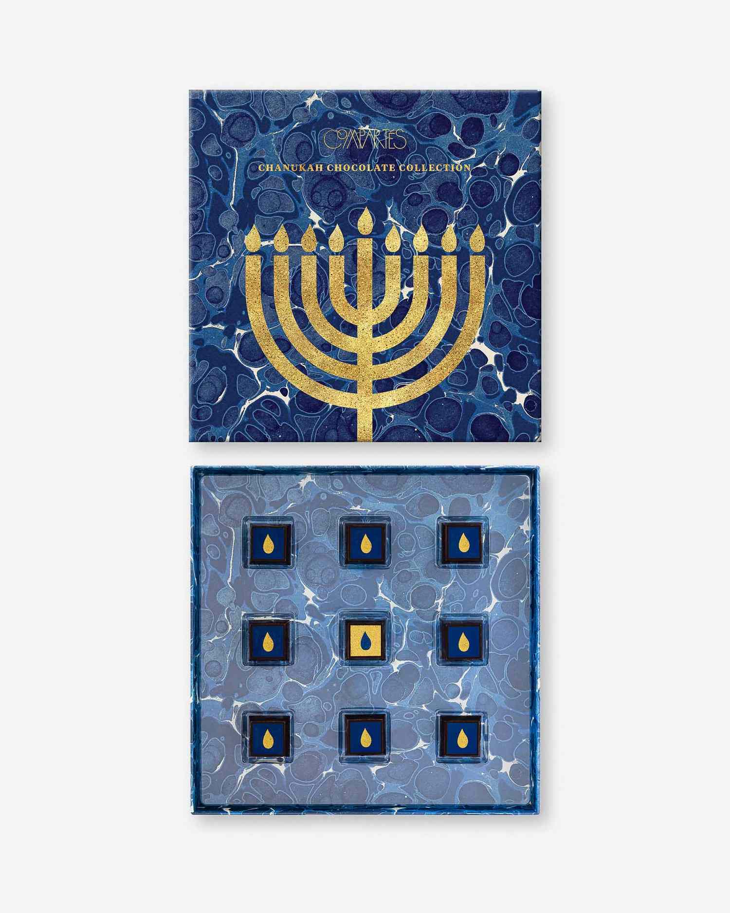 Gift box with a Hanukkah theme containing nine gourmet chocolate pieces decorated with a menorah design on the lid