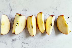 Sliced apple pieces arranged on a lightly textured surface