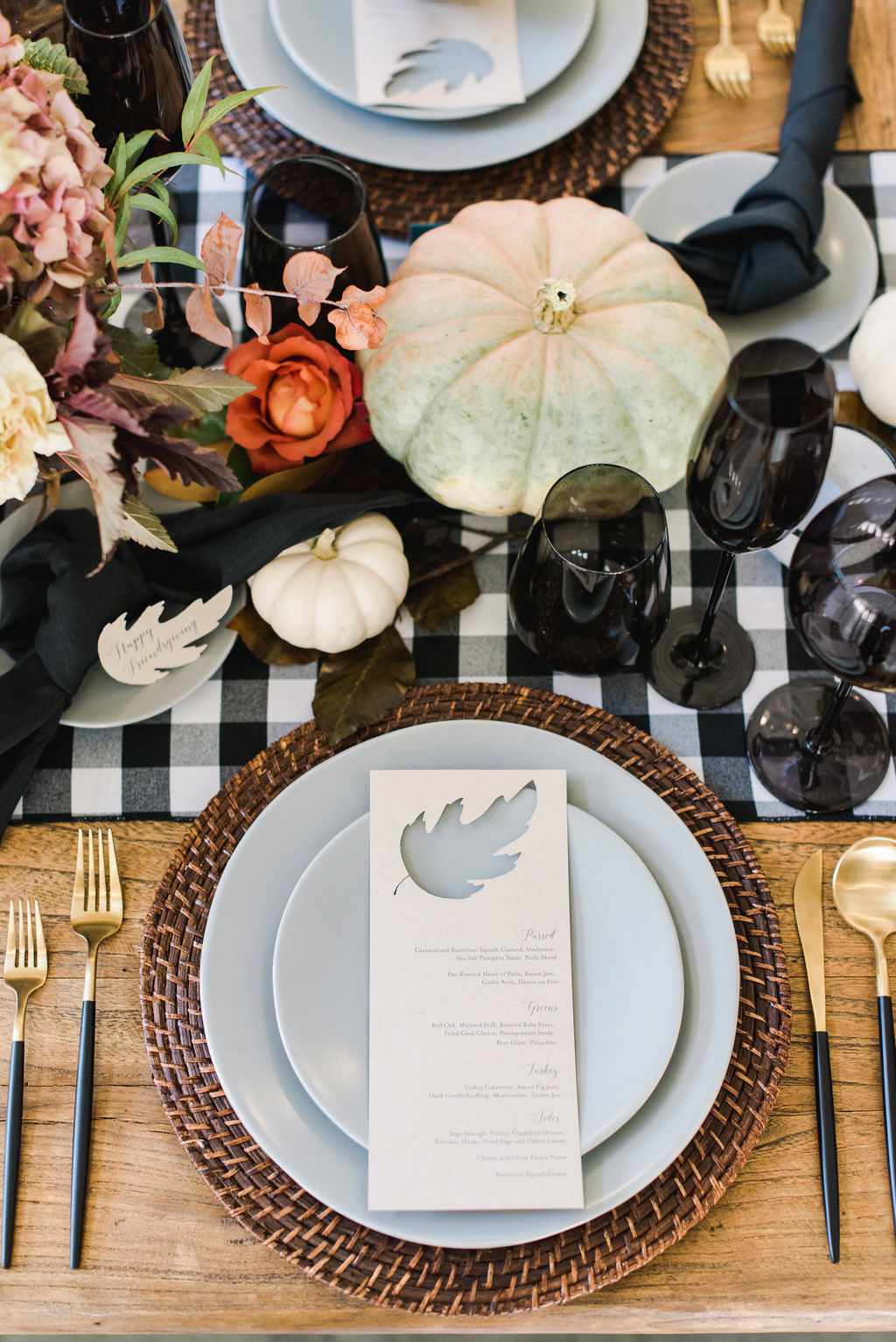 Thanksgiving centerpiece with black colored glassware and pumpkins