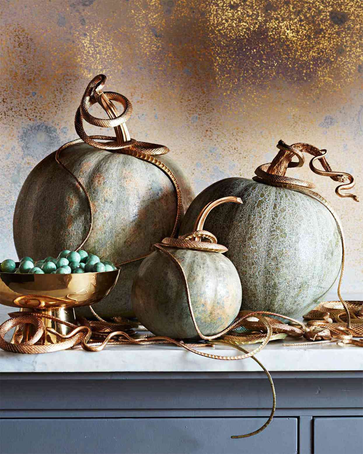 pumpkins adorned with gold snakes