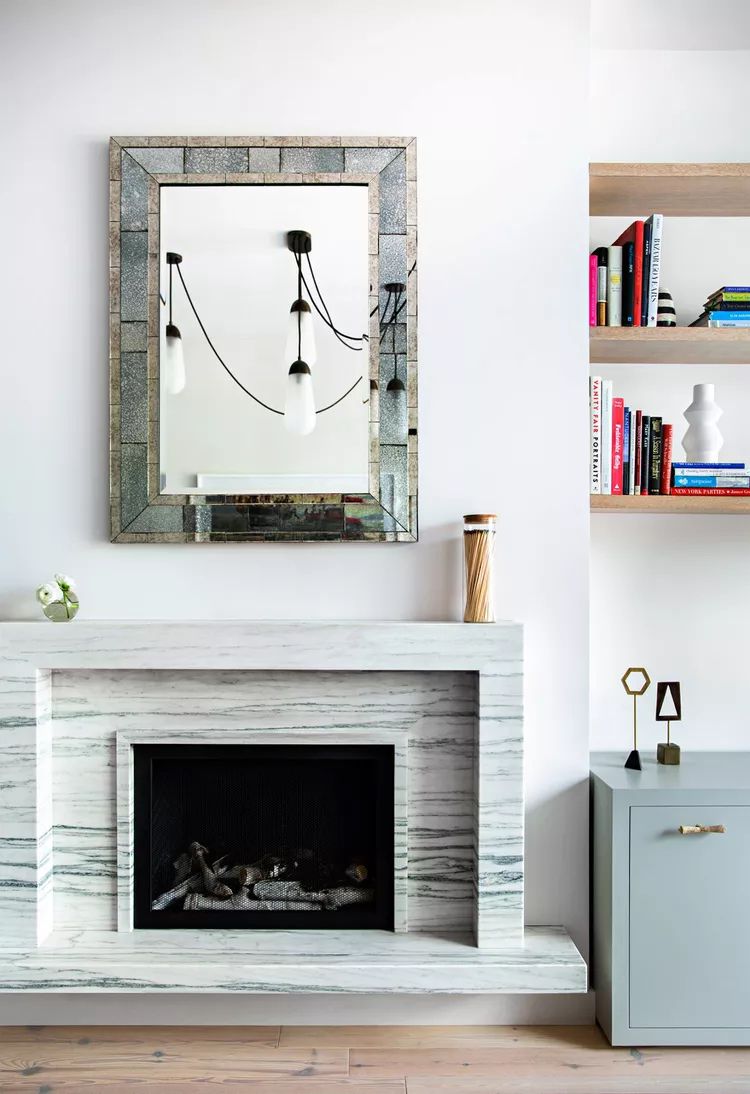 gray fireplace mantel with minimalist art
