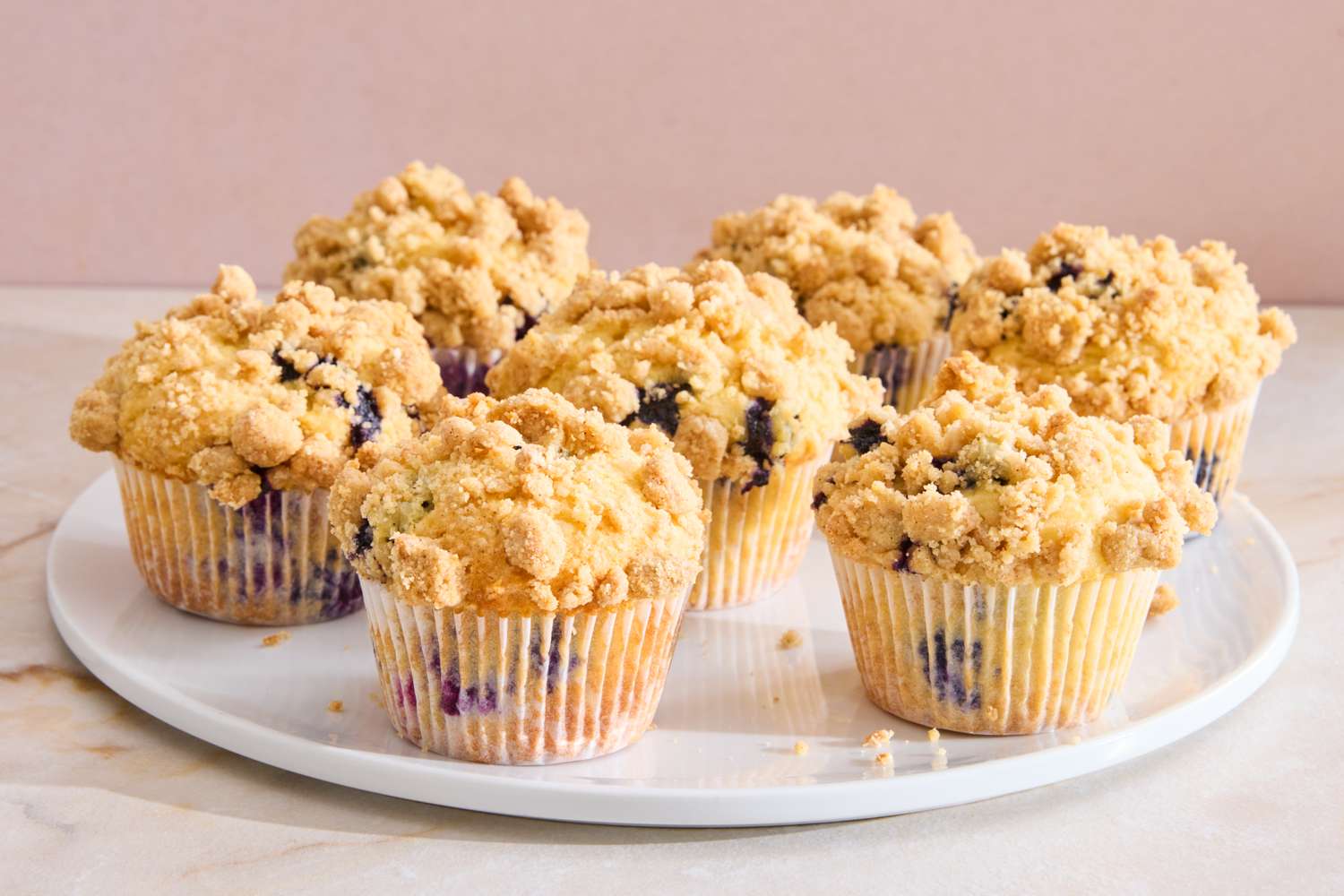 A plate of blueberry muffins topped with crumble