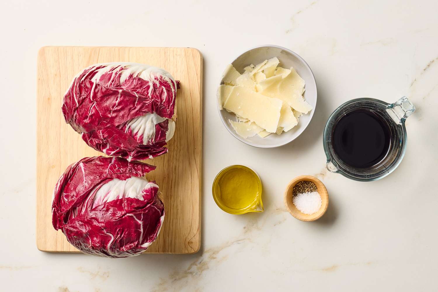 Ingredients for roasted radicchio including radicchio heads parmesan cheese olive oil balsamic vinegar and salt