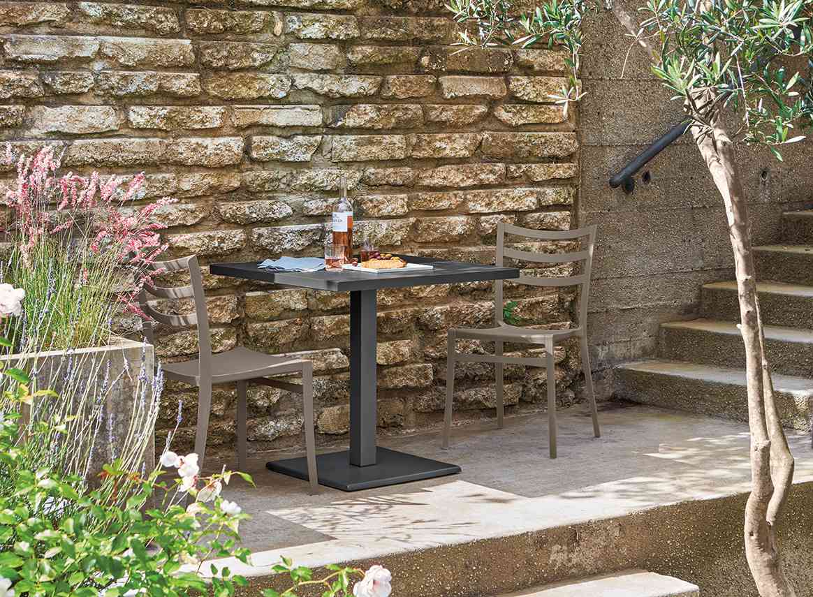 small black table brown chairs patio outside