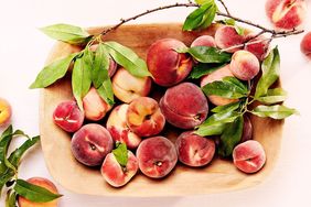 Wooden bowl with peaches