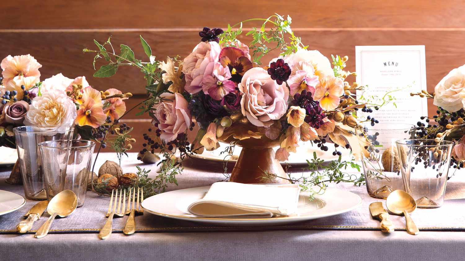 Table setting with floral centerpiece with gold flatware