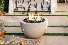 Outdoor fire pit with chairs and barstools on a patio