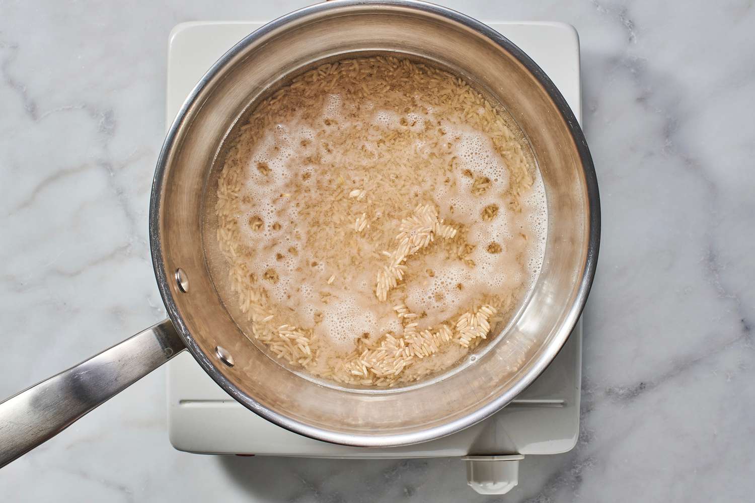 brown rice and water in pan