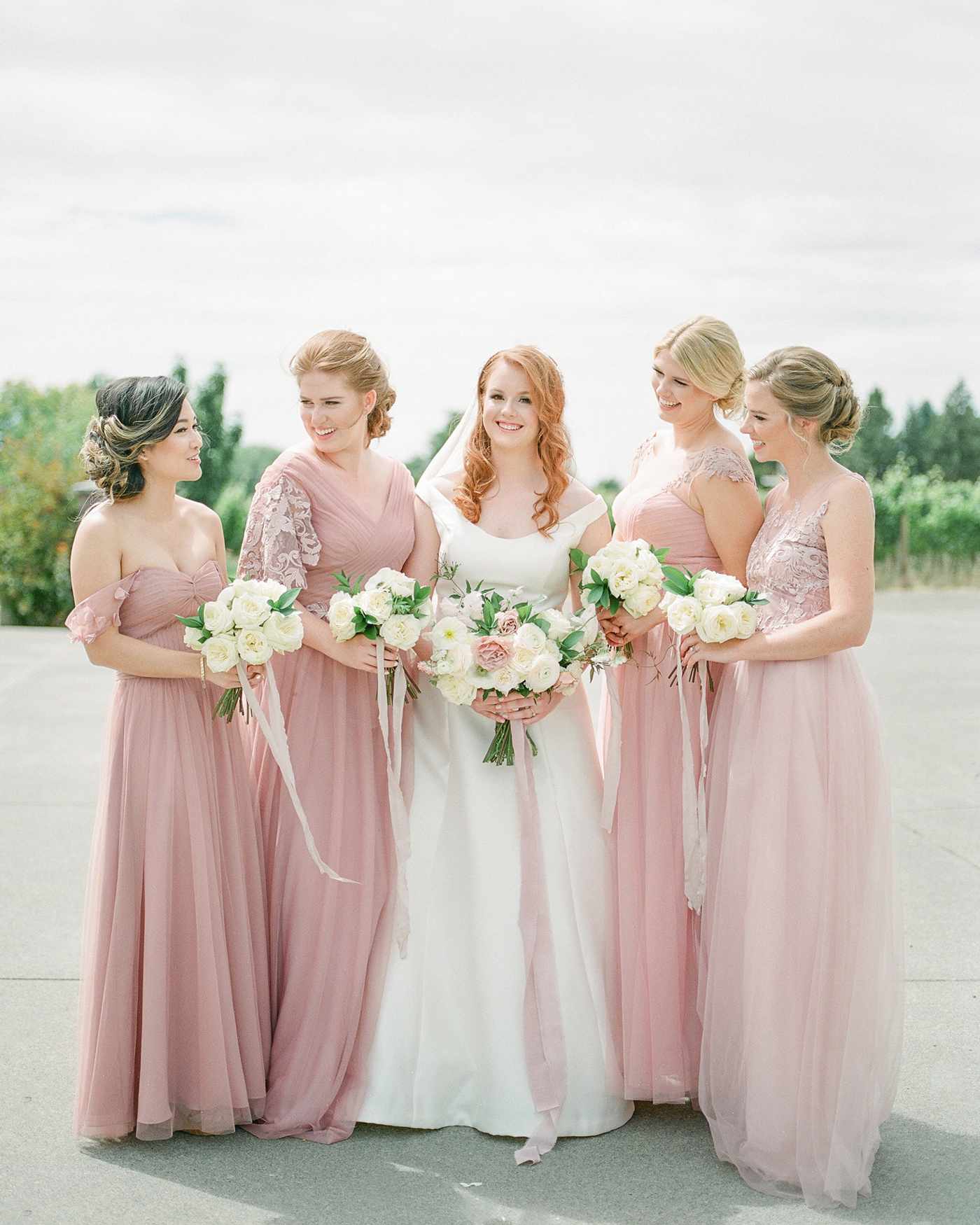 bridesmaids wearing blush colored gowns