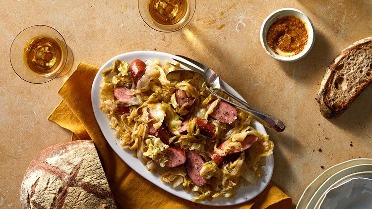 fried cabbage with sausage on orange table