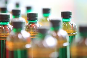 Array of bottled beverages with various liquid levels and caps