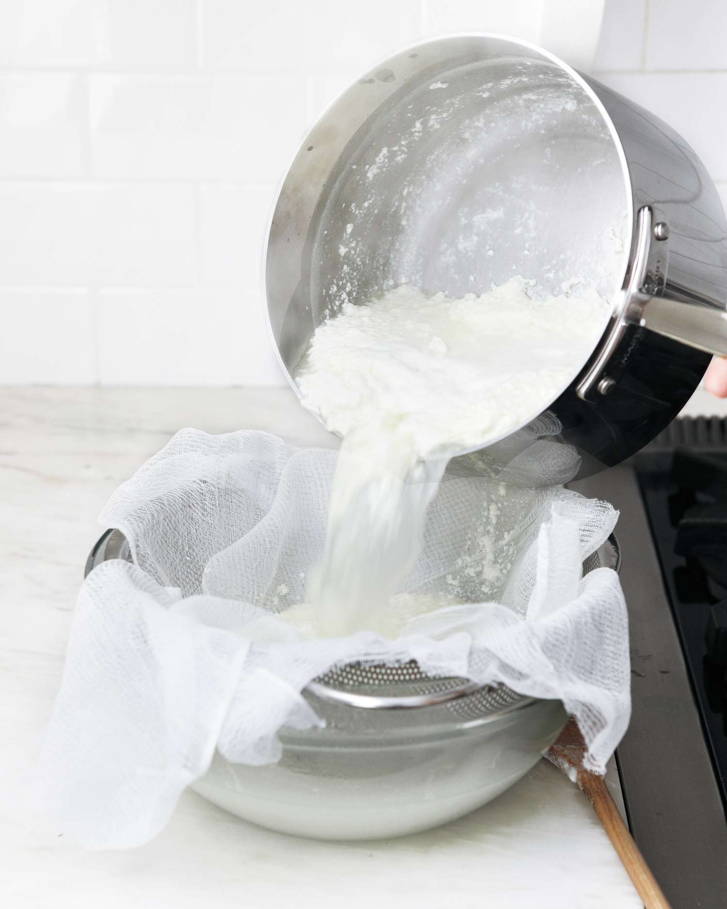 draining homemade ricotta through cheesecake