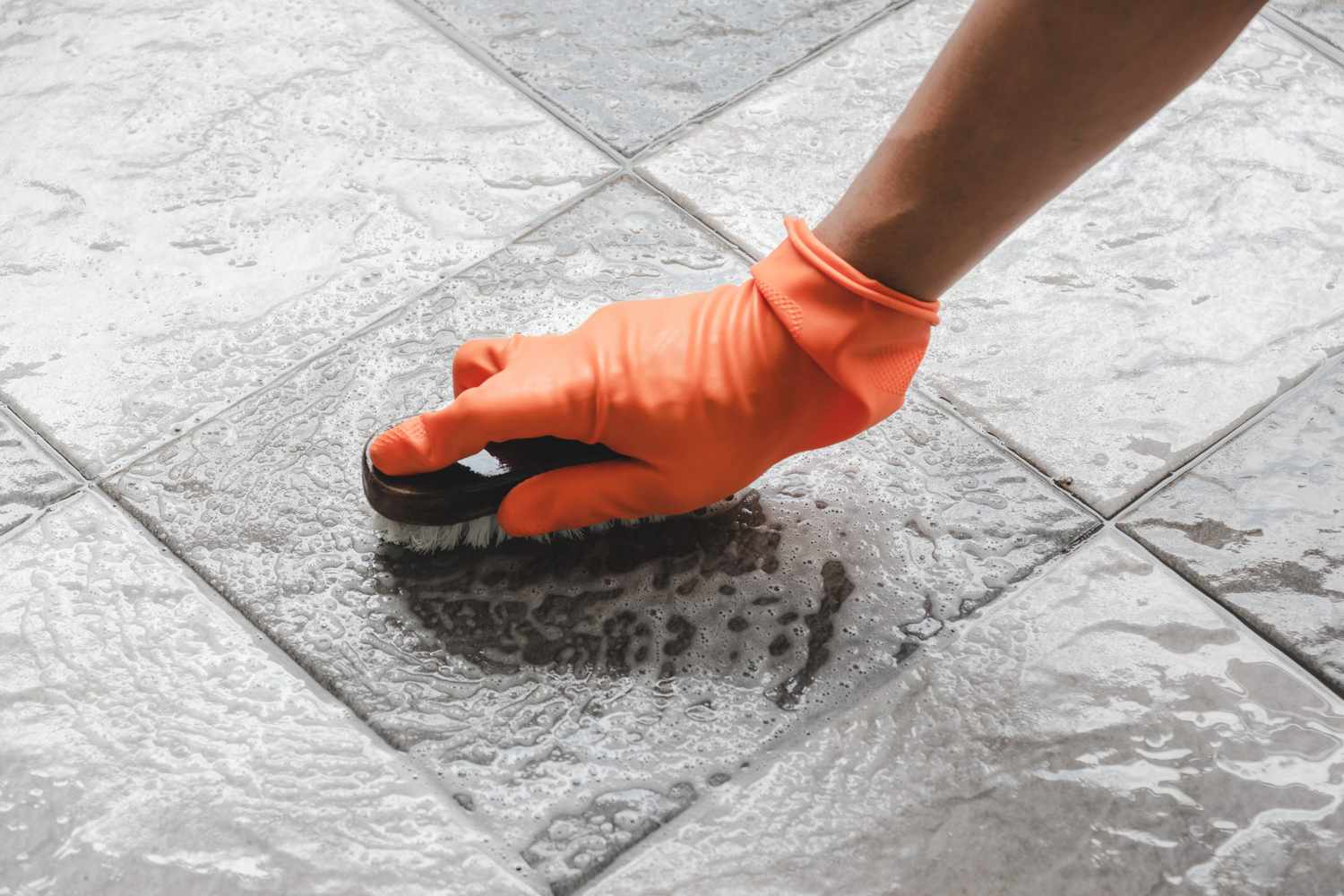 scrubbing bathroom tile floor