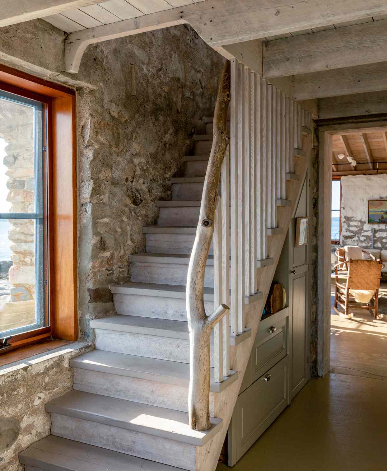 rustic main house staircase with driftwood banister
