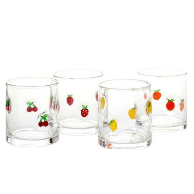 Four small glasses with fruit designs including cherries strawberries lemons and oranges