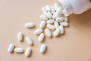 A bottle of pills spilled onto a surface