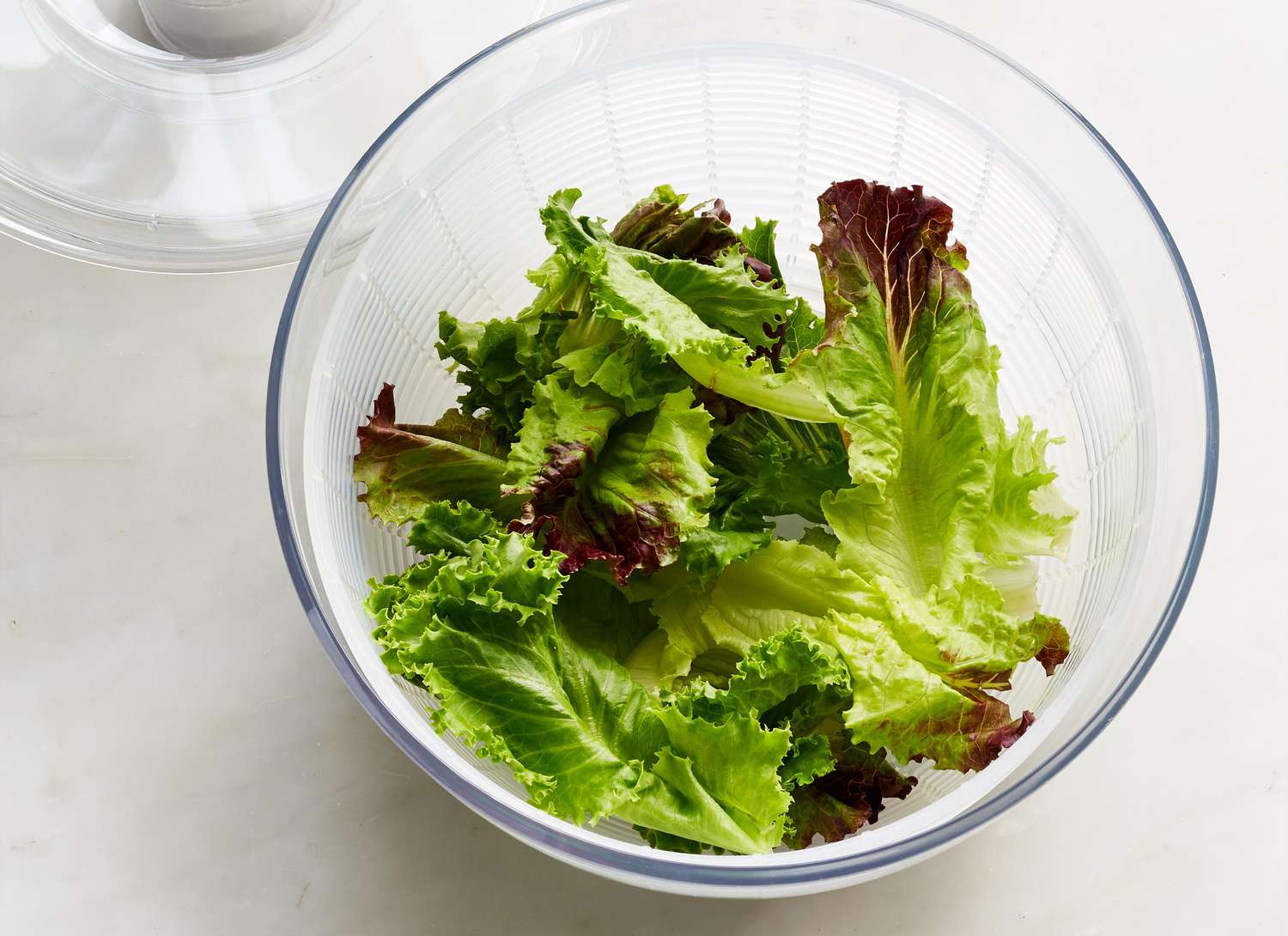 overhead view of lettuce in a salad spinner