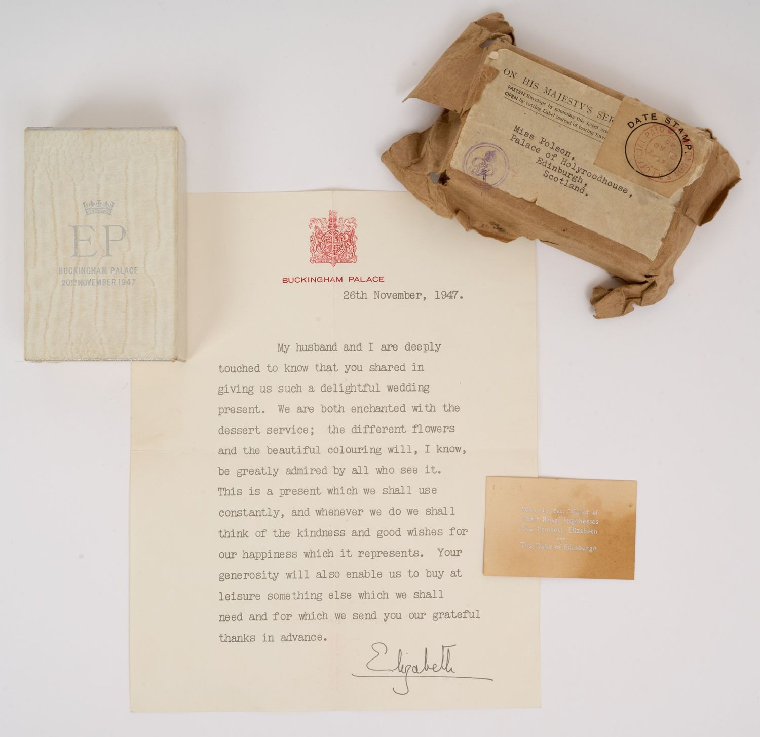 A collection of items including a letter a wrapped cardboard casing and a card