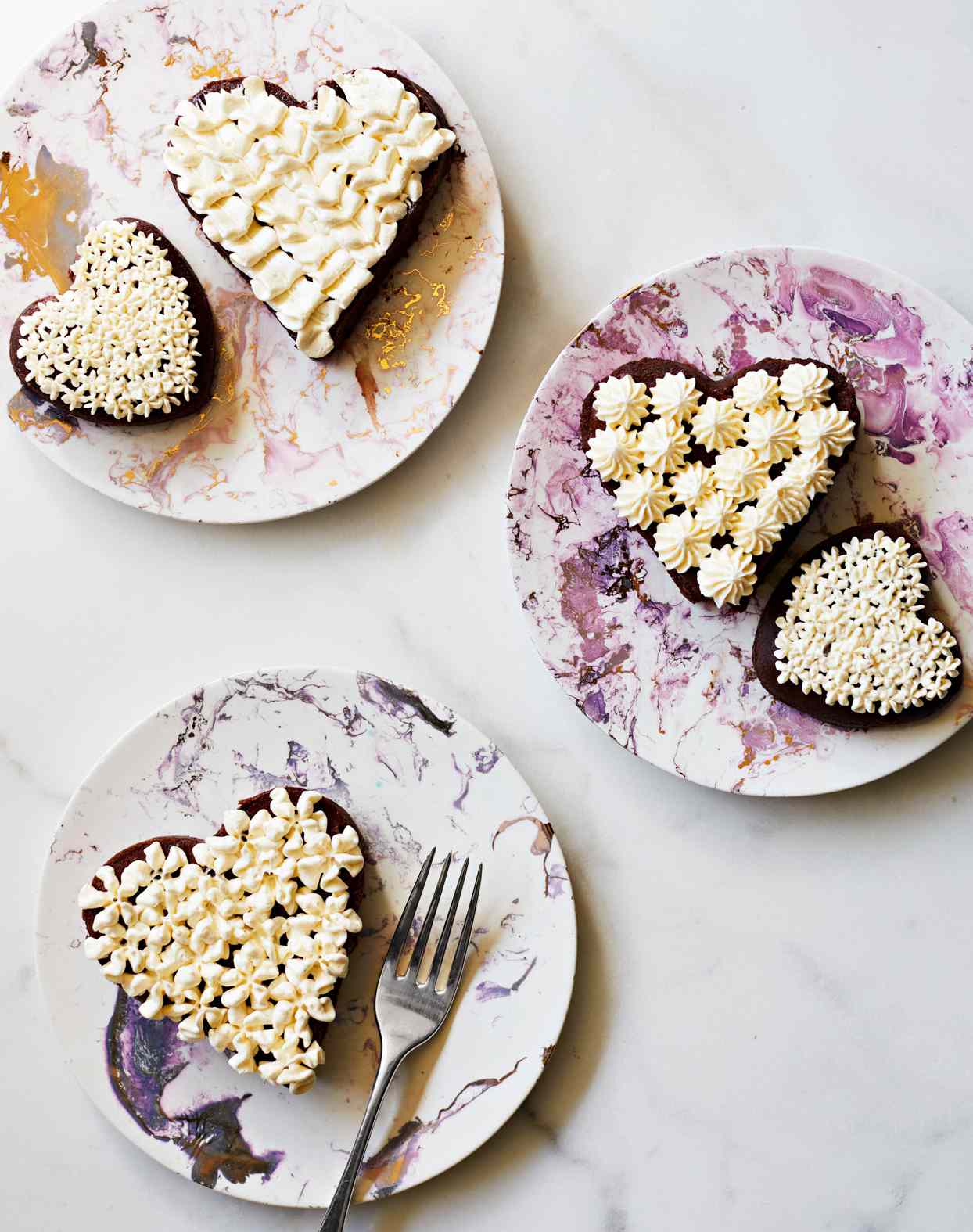 flourless chocolate heart mini cakes topped with swiss-meringue buttercream