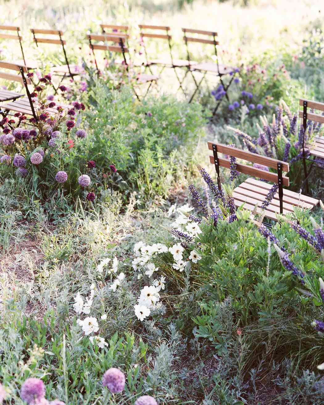 purple and white flowers with greenery wooden chairs