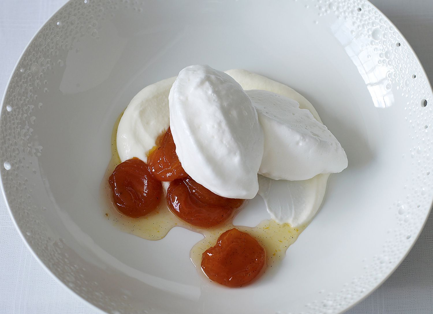 overhead view of meringue with fruit on a white plate