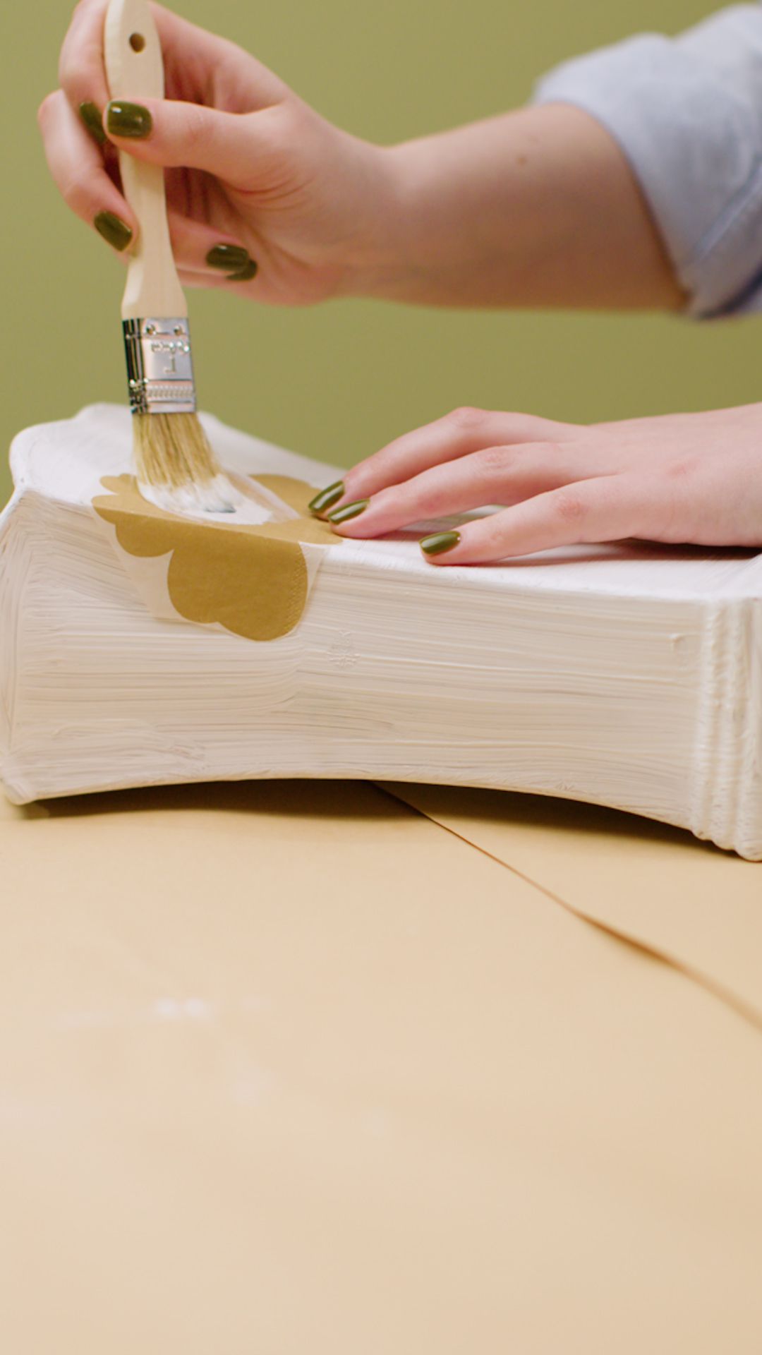 Person decoupaging a vase