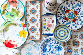 Various designs of colorful ceramic plates arranged flat on the white surface