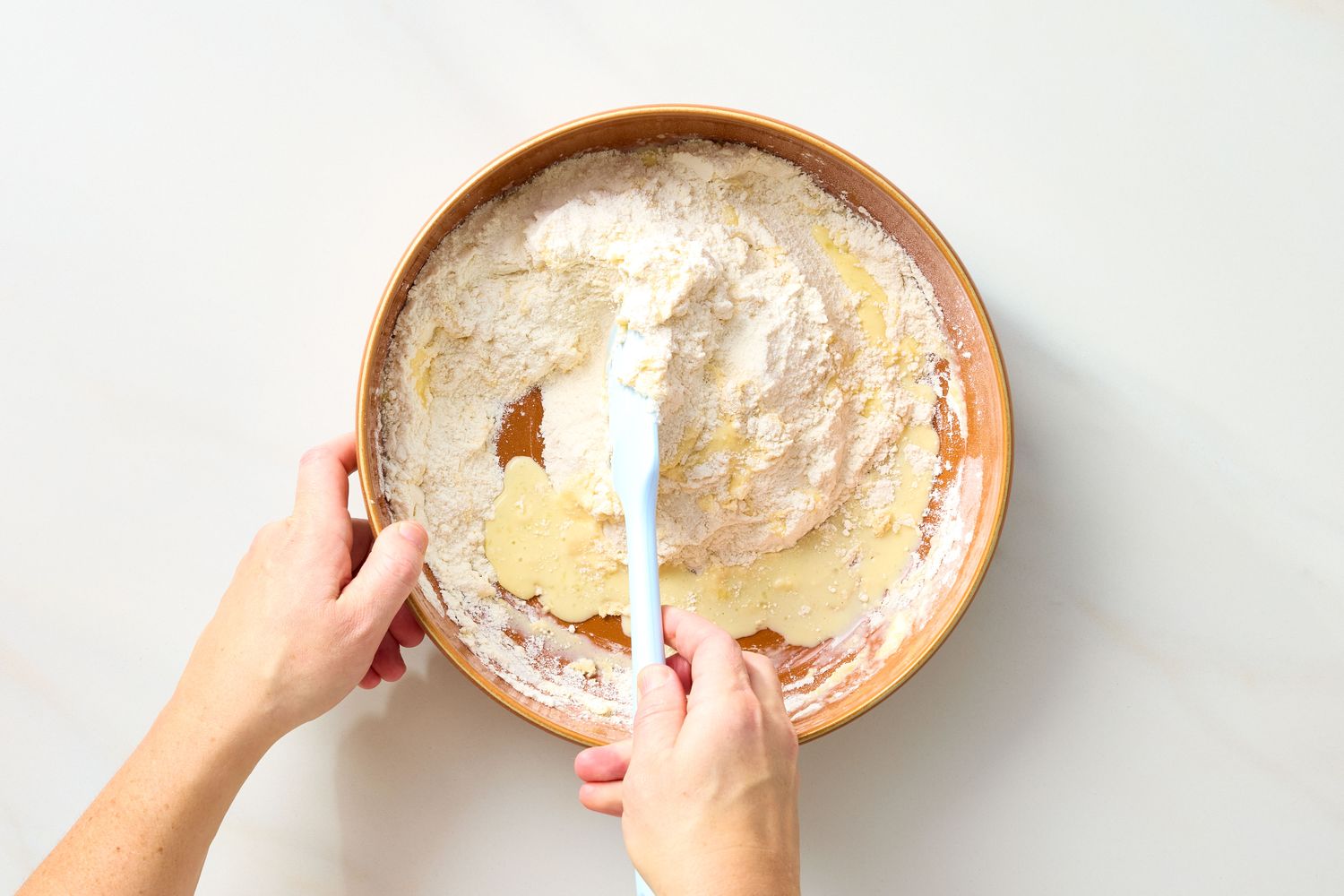 Mixing dough in a bowl with a spatula