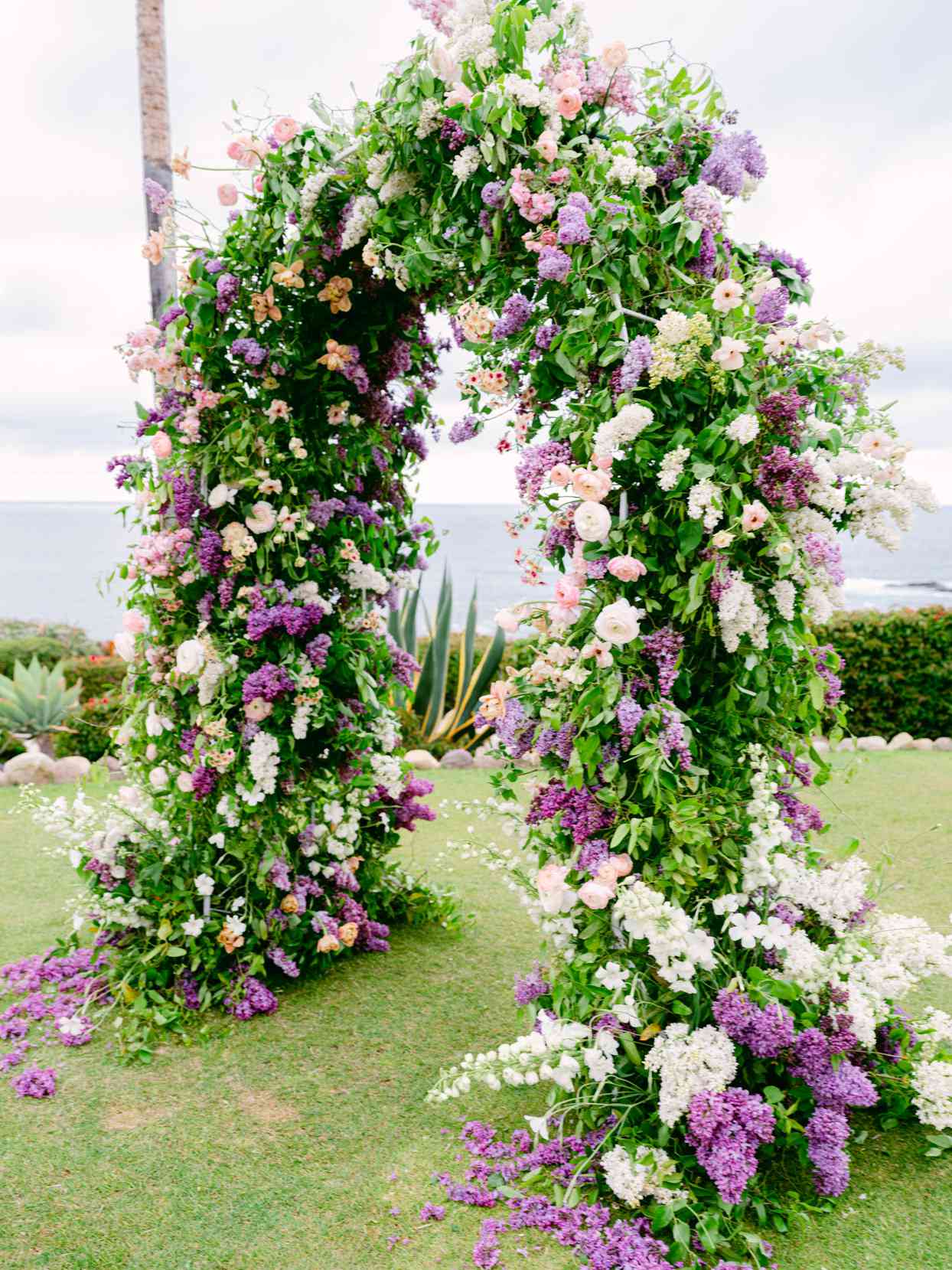 large purple and white floral wedding arch