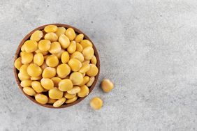 A bowl of lupini beans on a gray surface
