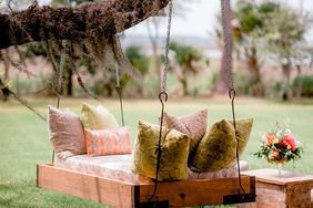 Swinging bench with pillows