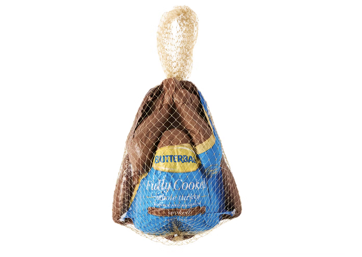 A packaged frozen turkey wrapped in netting with visible label