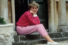 Diana, Princess of Wales, sitting outside a building on stairs