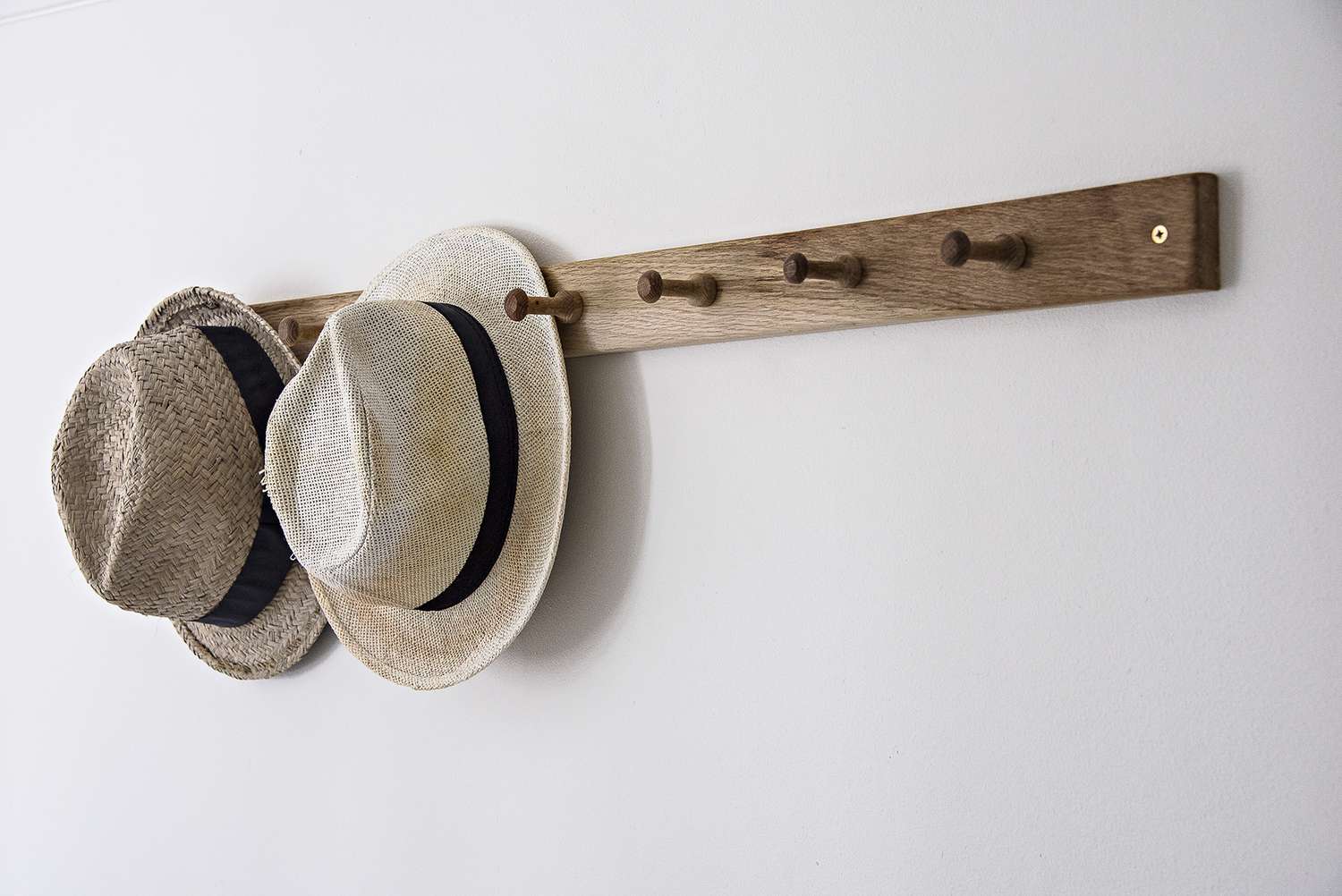 straw hats on hooks