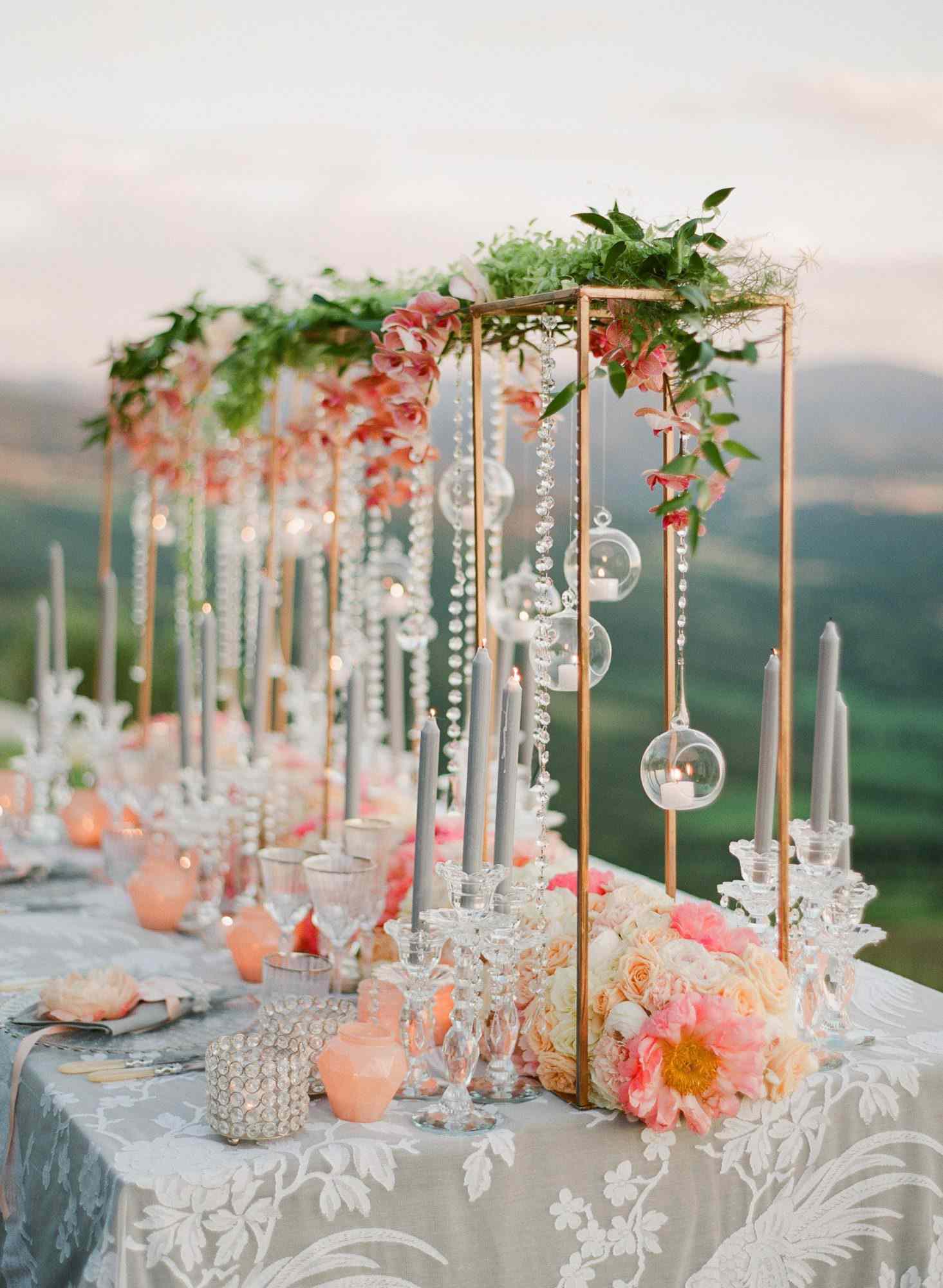 tall centerpiece with pink garden roses and ornaments