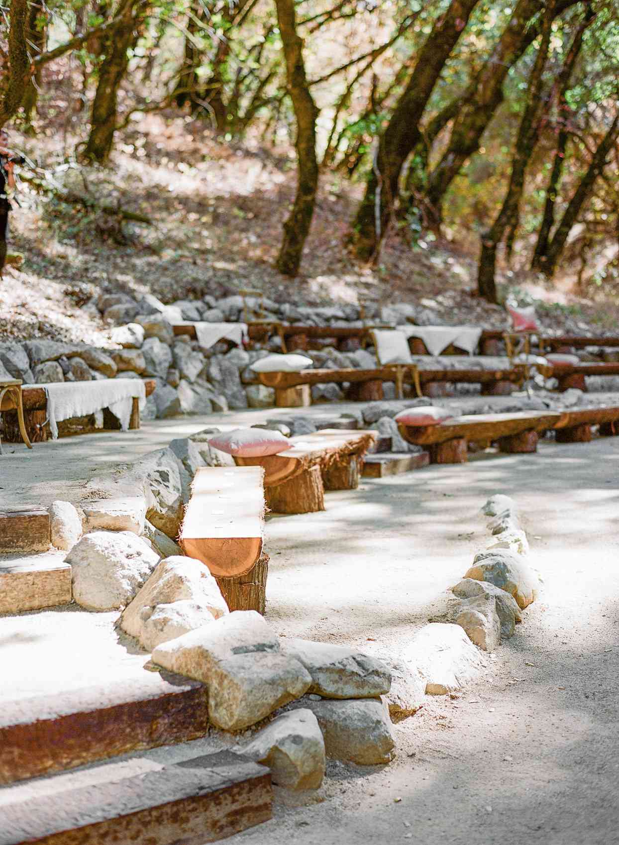 rustic outdoor wedding ceremony rock and wooden benches
