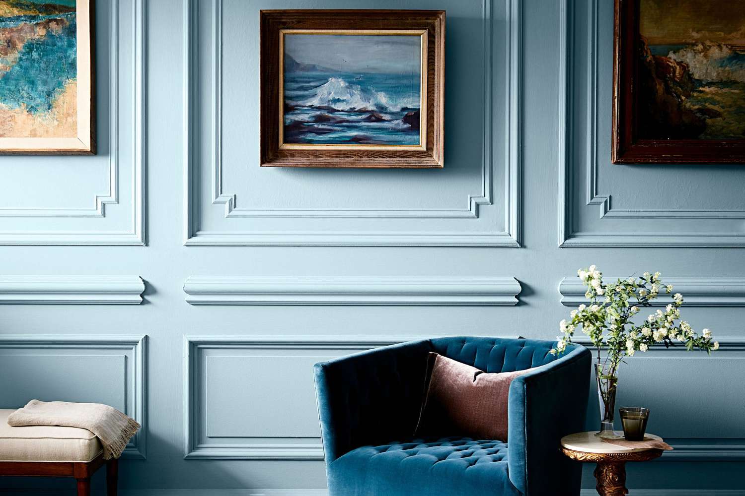 blue living room with art and picture frame molding