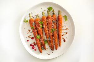 roasted carrots with parsley on white plate