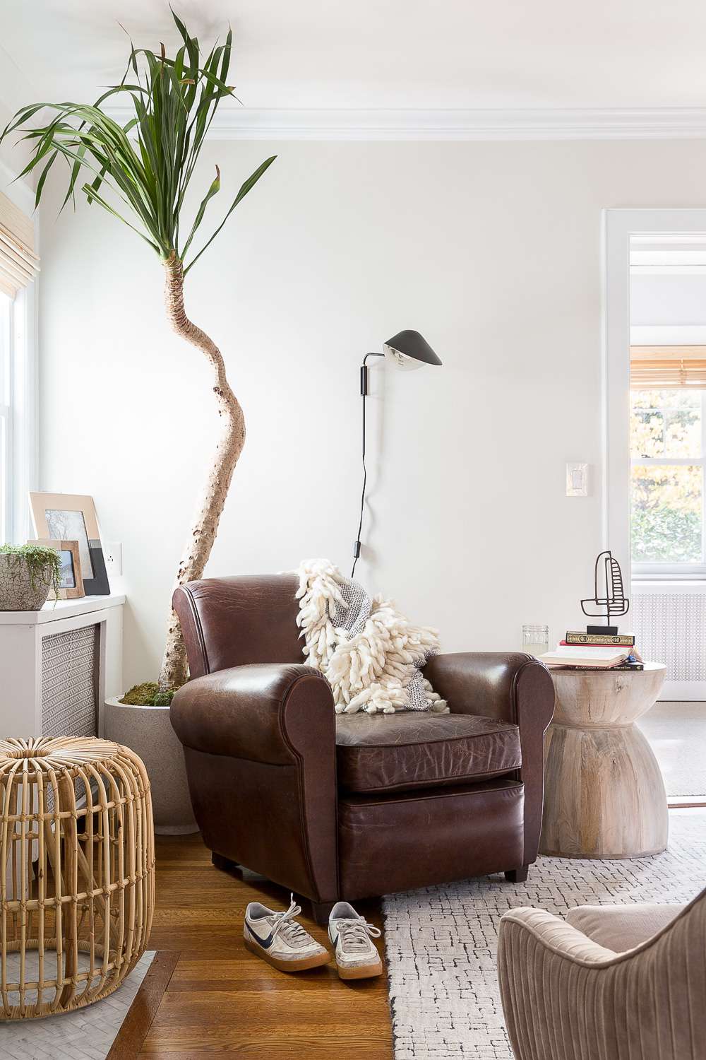 distressed leather armchair in neutral-colored living room
