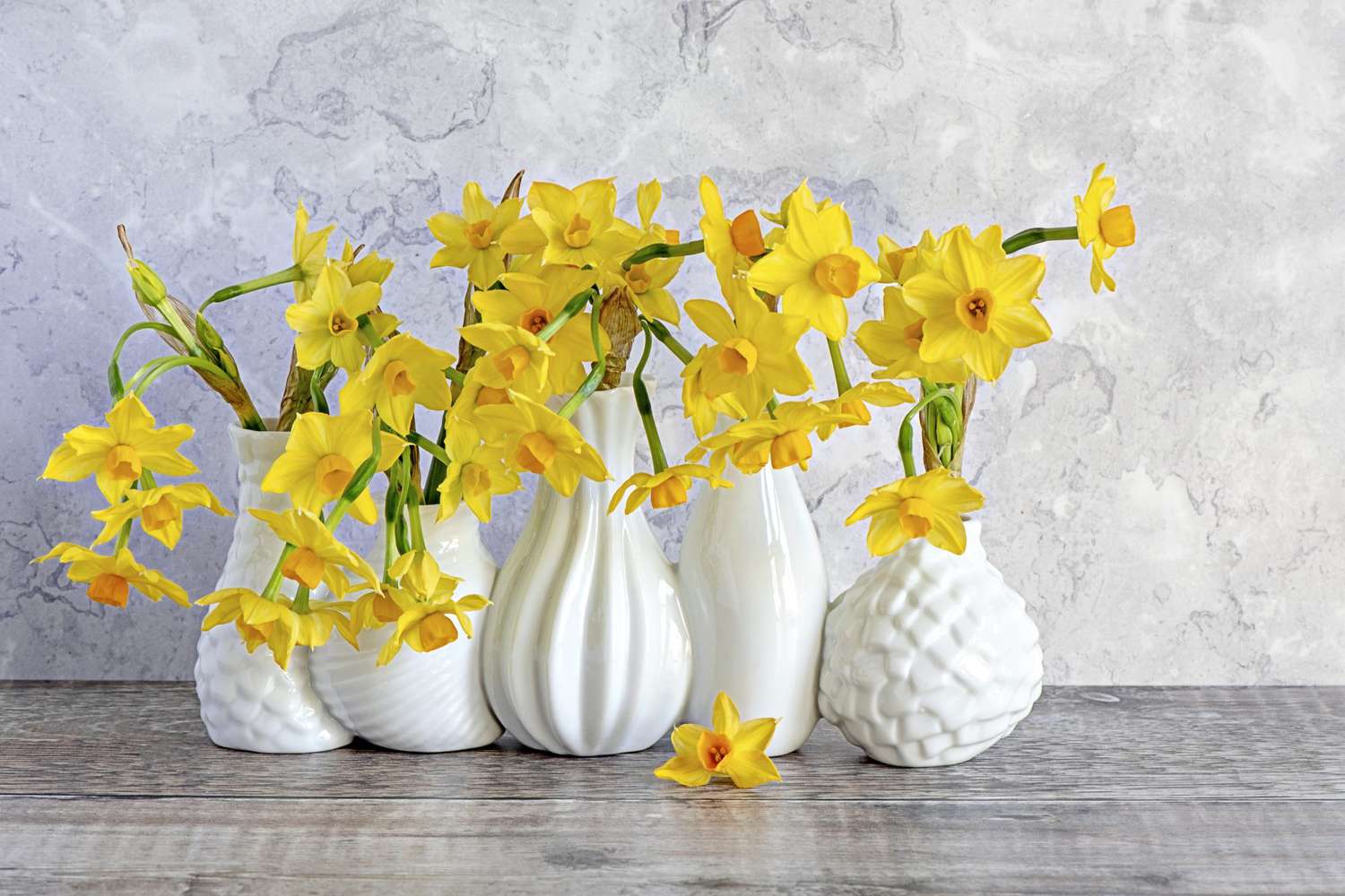 yellow daffodils bouquets in white vases