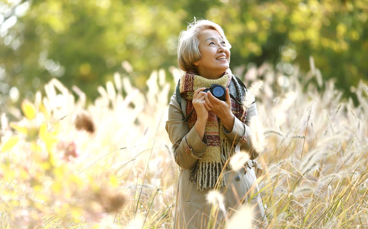 woman holding a camera in a field